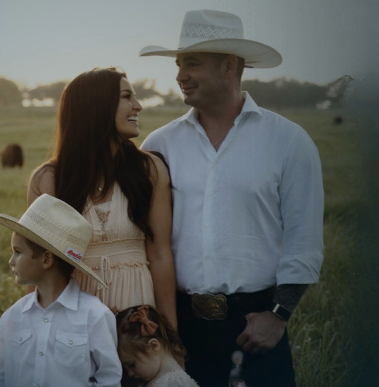 James Bradford with his wife and two children in a Texas field